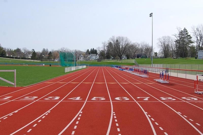 Windscreen along a track and field facility fence